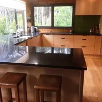 Plywood Doors With Handle Cutouts And Black Pearl Granite Benchtops