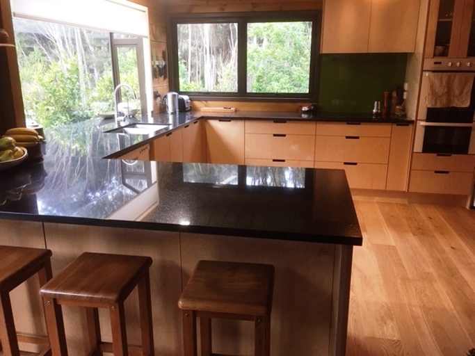 Plywood Doors With Handle Cutouts And Black Pearl Granite Benchtops
